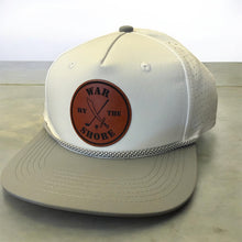 Load image into Gallery viewer, Beige cap with brown leather patch on a light wooden surface